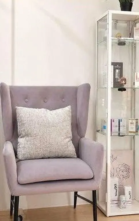 Lilac armchair beside the product cabinet